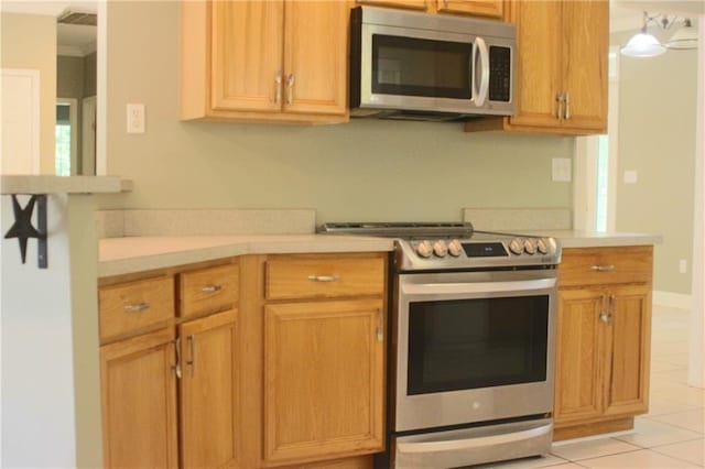 66165 Hickory Dr, Pearl River, LA 70452 - kitchen with stainless steel appliances, light countertops, and light tile patterned floors