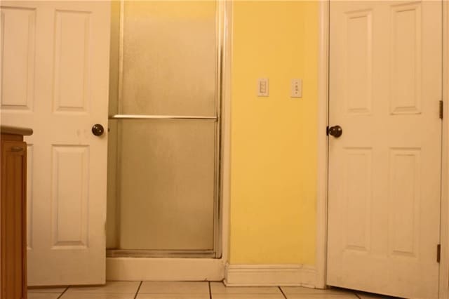 66165 Hickory Dr, Pearl River, LA 70452 - bathroom featuring tile patterned flooring, baseboards, and an enclosed shower