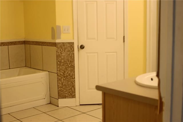 66165 Hickory Dr, Pearl River, LA 70452 - full bathroom with tile patterned floors, tile walls, a bath, wainscoting, and vanity