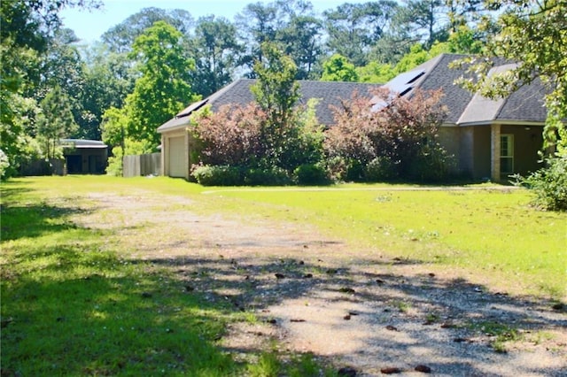 66165 Hickory Dr, Pearl River, LA 70452 - view of grassy yard with an attached garage