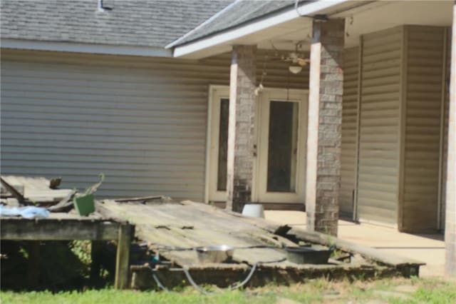 66165 Hickory Dr, Pearl River, LA 70452 - view of exterior entry featuring a shingled roof and stone siding