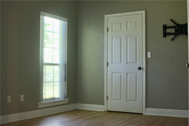 66165 Hickory Dr, Pearl River, LA 70452 - empty room with wood finished floors, baseboards, and plenty of natural light