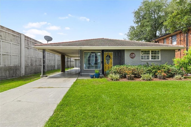228 W Kenilworth St, New Orleans, LA 70124 - view of front of house with an attached carport, driveway, and brick siding