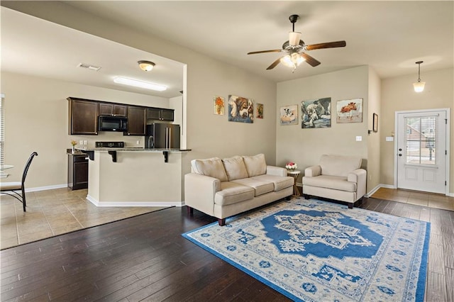20413 Palm Blvd, Covington, LA 70435 - living area with hardwood / wood-style flooring, ceiling fan, and baseboards