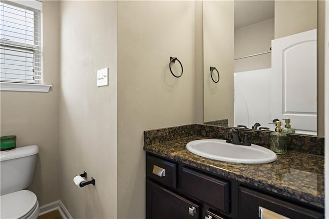 20413 Palm Blvd, Covington, LA 70435 - bathroom featuring toilet, vanity, and baseboards