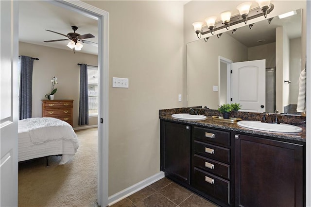 20413 Palm Blvd, Covington, LA 70435 - full bath featuring baseboards, ceiling fan, connected bathroom, double vanity, and tile patterned floors