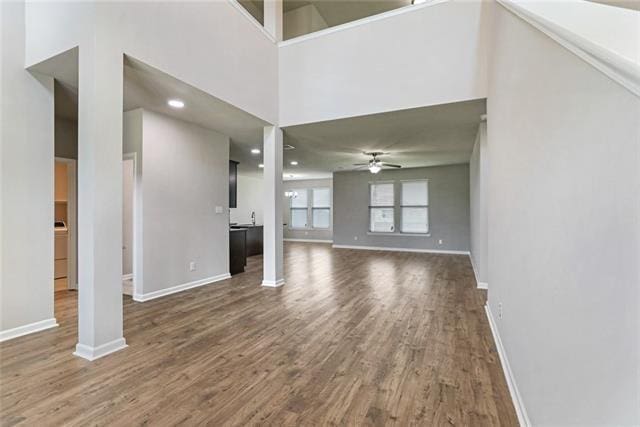 693 Lakeshore Village Dr, Slidell, LA 70461 - unfurnished living room with a ceiling fan, dark wood-style floors, baseboards, and recessed lighting