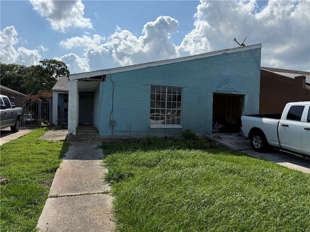 16 Petit Bayou Ln, New Orleans, LA 70129 - view of front facade featuring a front yard and brick siding