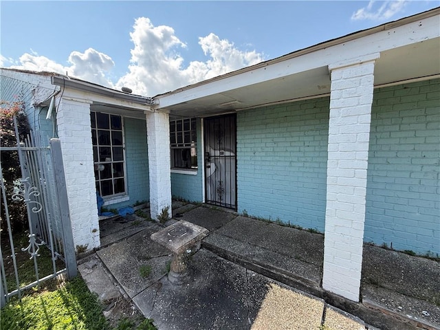 16 Petit Bayou Ln, New Orleans, LA 70129 - view of exterior entry with brick siding