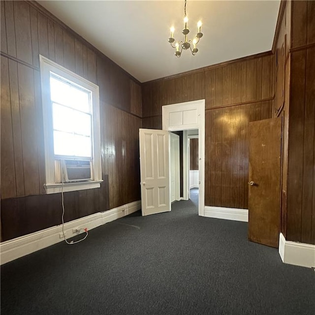 937-939 N Claiborne Ave, New Orleans, LA 70116 - empty room with a chandelier, dark carpet, and wood walls