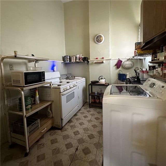 937-939 N Claiborne Ave, New Orleans, LA 70116 - kitchen with independent washer and dryer, white electric range, and light flooring