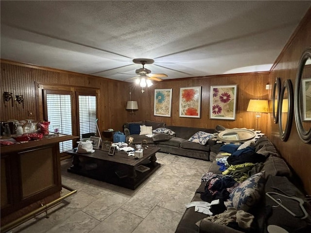 2132 Missille St, Harvey, LA 70058 - living area with a ceiling fan, wood walls, and a textured ceiling