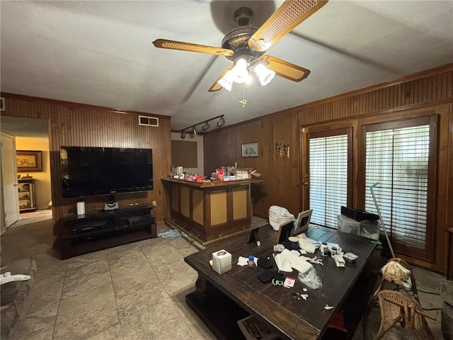 2132 Missille St, Harvey, LA 70058 - living area with wood walls and a ceiling fan
