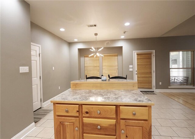47013 Rivergate Dr, Robert, LA 70455 - kitchen with light tile patterned flooring, light countertops, baseboards, pendant lighting, and recessed lighting