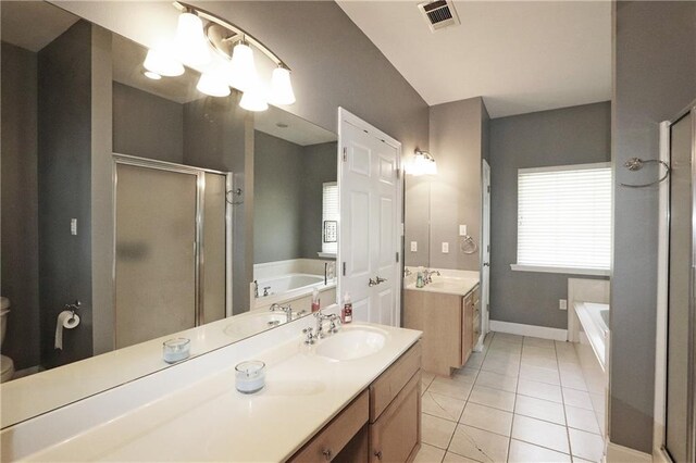 47013 Rivergate Dr, Robert, LA 70455 - full bathroom featuring vanity, a shower stall, a garden tub, tile patterned floors, and plenty of natural light