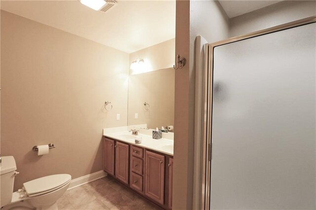 47013 Rivergate Dr, Robert, LA 70455 - bathroom featuring toilet, a shower stall, double vanity, tile patterned floors, and baseboards