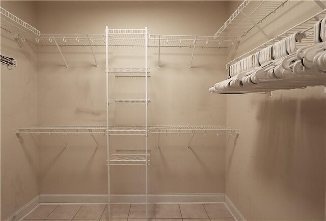 47013 Rivergate Dr, Robert, LA 70455 - walk in closet featuring light tile patterned floors