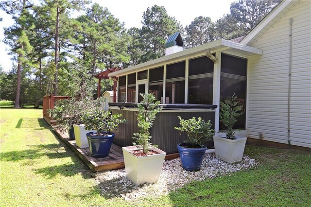 47013 Rivergate Dr, Robert, LA 70455 - view of side of home with a sunroom, a yard, and a chimney