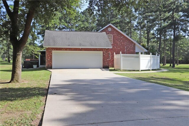 47013 Rivergate Dr, Robert, LA 70455 - view of side of home with brick siding, driveway, an attached garage, and roof with shingles