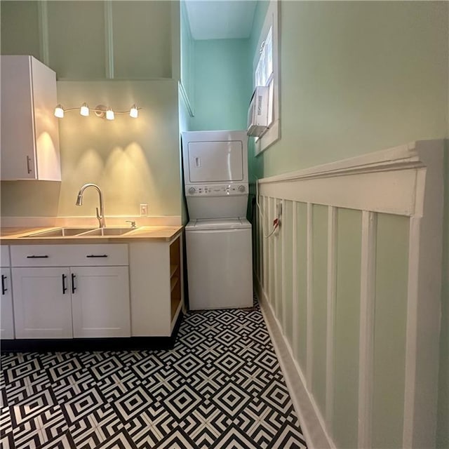 1915-1917 Bayou Rd, New Orleans, LA 70116 - laundry area featuring stacked washer / dryer and tile patterned floors
