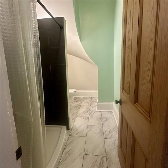 1915-1917 Bayou Rd, New Orleans, LA 70116 - bathroom featuring marble finish flooring, baseboards, toilet, and a shower stall