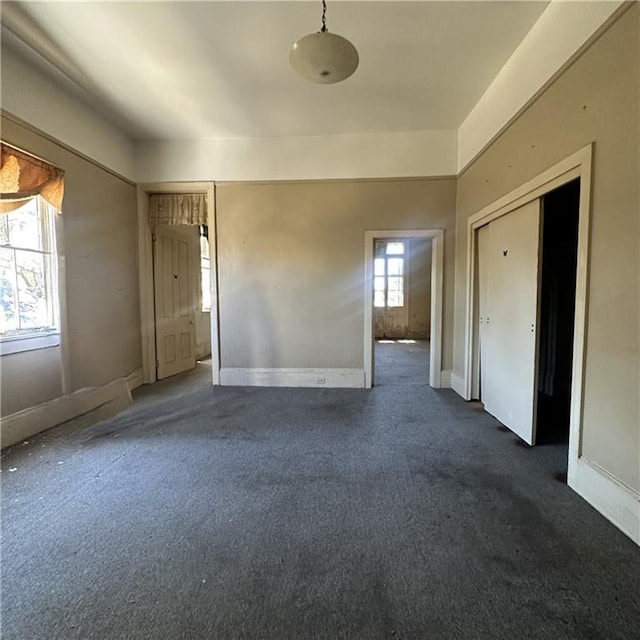 1915-1917 Bayou Rd, New Orleans, LA 70116 - spare room featuring dark carpet and baseboards