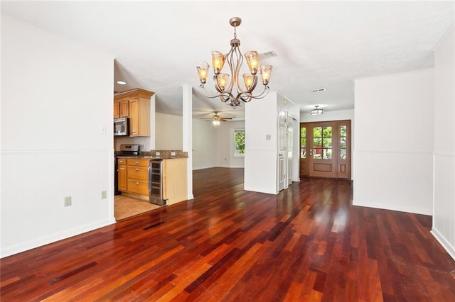 120 Pine Dr, Covington, LA 70433 - unfurnished living room featuring a chandelier, wood finished floors, ceiling fan, wine cooler, and baseboards