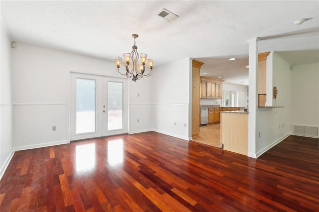 120 Pine Dr, Covington, LA 70433 - unfurnished living room with a chandelier, wood finished floors, french doors, baseboards, and a textured ceiling