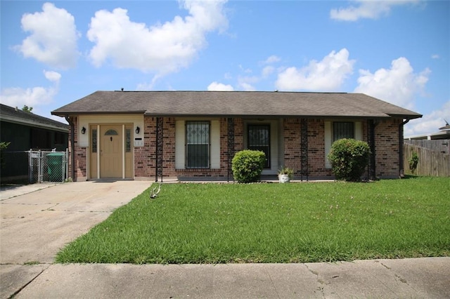 116 Southern Ct, Avondale, LA 70094 - view of front facade with brick siding, concrete driveway, and a gate