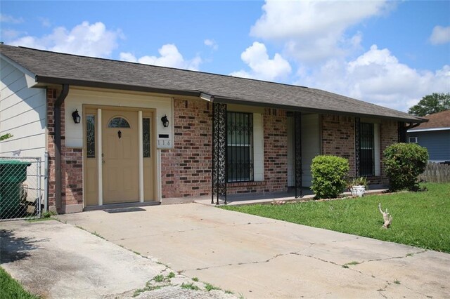 116 Southern Ct, Avondale, LA 70094 - property entrance featuring brick siding, a lawn, and central AC unit