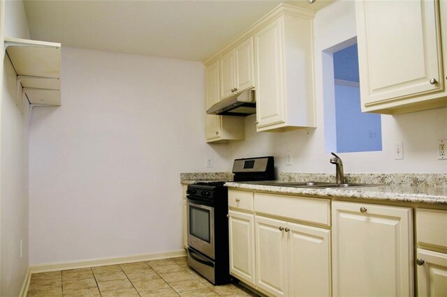 116 Southern Ct, Avondale, LA 70094 - kitchen with gas stove, under cabinet range hood, a sink, light tile patterned floors, and light stone countertops