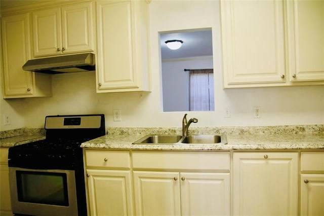 116 Southern Ct, Avondale, LA 70094 - kitchen with stainless steel gas range, under cabinet range hood, a sink, and light stone countertops
