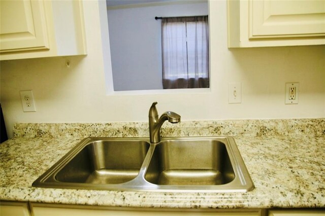 116 Southern Ct, Avondale, LA 70094 - kitchen view of a sink, white cabinetry, and light stone countertops