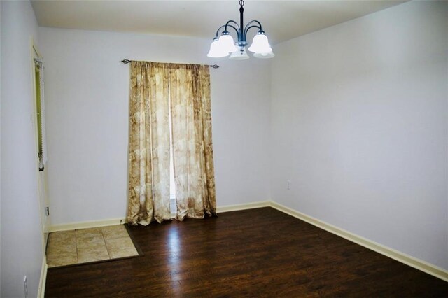 116 Southern Ct, Avondale, LA 70094 - empty room with wood finished floors, a chandelier, and baseboards
