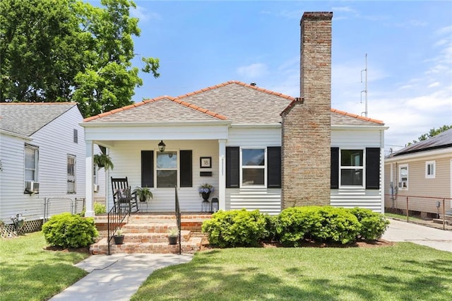 18 Davis Blvd, Jefferson, LA 70121 - view of front of home featuring a porch, a chimney, and cooling unit