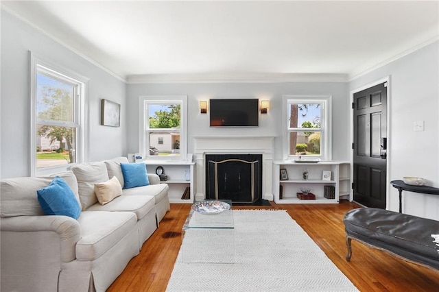 18 Davis Blvd, Jefferson, LA 70121 - living area featuring healthy amount of natural light, a fireplace with flush hearth, wood finished floors, and ornamental molding