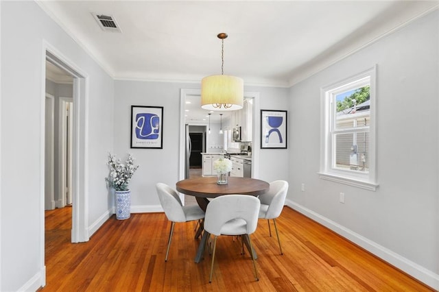 18 Davis Blvd, Jefferson, LA 70121 - dining space featuring baseboards, light wood-style flooring, and ornamental molding