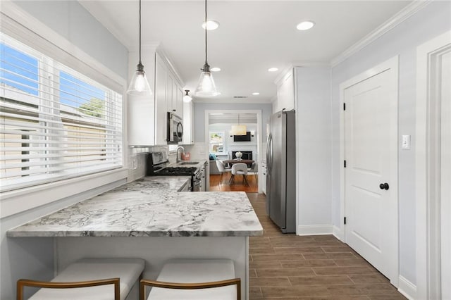 18 Davis Blvd, Jefferson, LA 70121 - kitchen featuring appliances with stainless steel finishes, white cabinets, crown molding, backsplash, and dark wood-style flooring