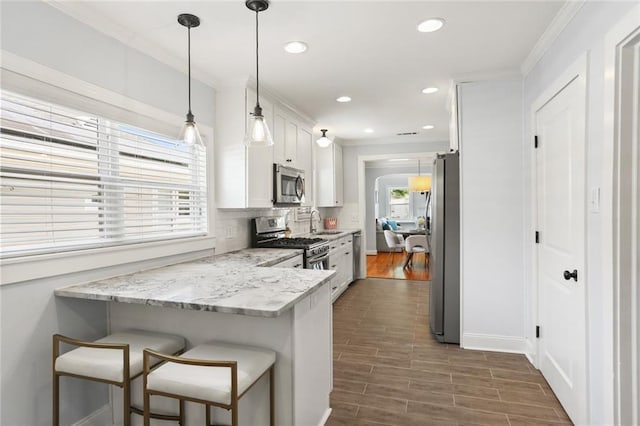 18 Davis Blvd, Jefferson, LA 70121 - kitchen with stainless steel appliances, white cabinets, a sink, crown molding, and tasteful backsplash