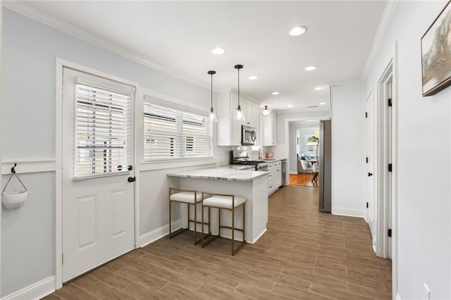 18 Davis Blvd, Jefferson, LA 70121 - kitchen with white cabinets, recessed lighting, a peninsula, a kitchen breakfast bar, and ornamental molding