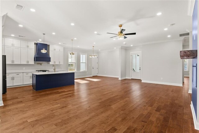 1109 David Dr, Metairie, LA 70003 - kitchen featuring custom range hood, a ceiling fan, open floor plan, recessed lighting, and baseboards