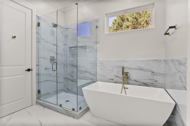 1109 David Dr, Metairie, LA 70003 - full bath featuring marble look tile flooring, tile walls, ornamental molding, a marble finish shower, and a soaking tub