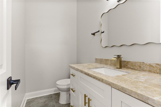 1109 David Dr, Metairie, LA 70003 - bathroom with baseboards, vanity, toilet, and tile patterned floors