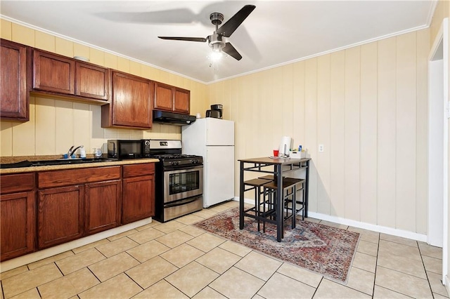 1031 Henriette Delille St Unit 7, New Orleans, LA 70116 - kitchen featuring stainless steel gas range, under cabinet range hood, freestanding refrigerator, black microwave, and crown molding