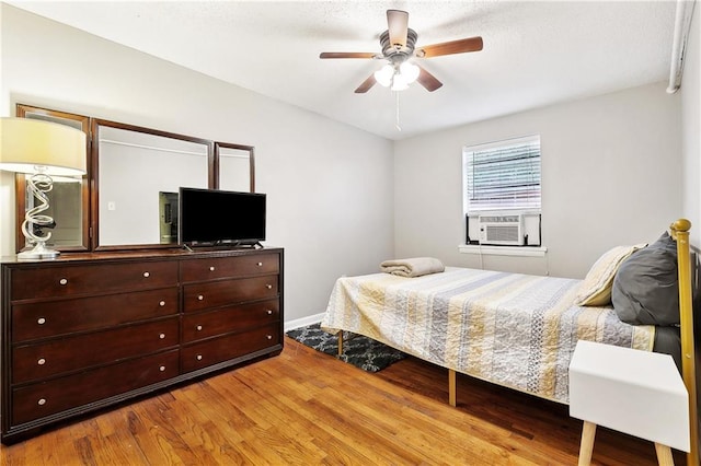 1031 Henriette Delille St Unit 7, New Orleans, LA 70116 - bedroom with wood finished floors, cooling unit, ceiling fan, and baseboards