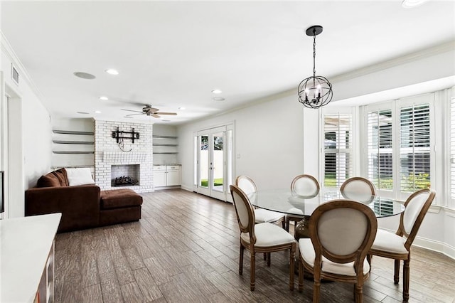 9108 Ormond Pl, River Ridge, LA 70123 - dining room with ornamental molding, wood finished floors, recessed lighting, a brick fireplace, and ceiling fan