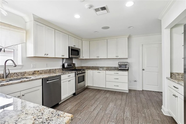 9108 Ormond Pl, River Ridge, LA 70123 - kitchen featuring appliances with stainless steel finishes, a sink, crown molding, dark wood-type flooring, and recessed lighting