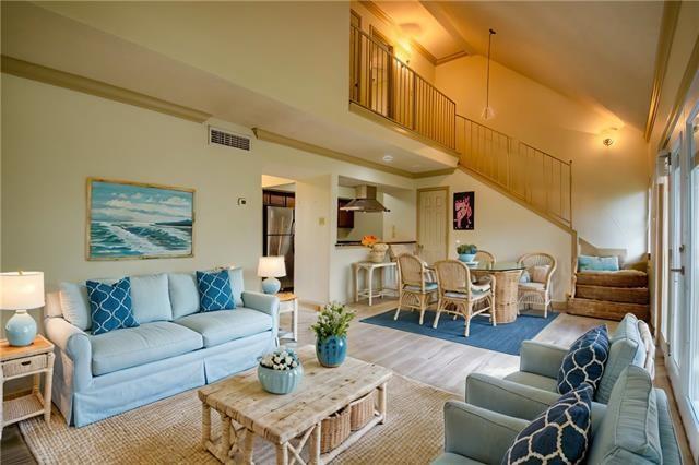 350 Atalin St Unit 11A, Mandeville, LA 70448 - living room featuring stairway, wood finished floors, and high vaulted ceiling