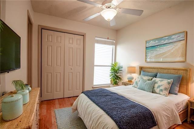 350 Atalin St Unit 11A, Mandeville, LA 70448 - bedroom featuring a closet, multiple windows, and wood finished floors