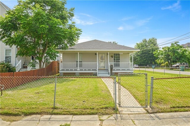 1401 Claiborne Dr, Jefferson, LA 70121 - bungalow with a porch, a gate, and roof with shingles
